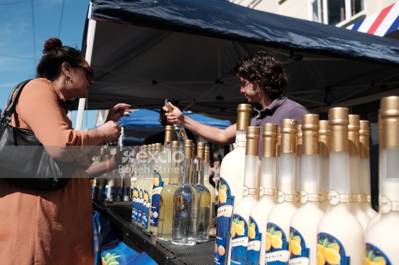 Woman buying a drink at a kiosk at Newtown festival 2021