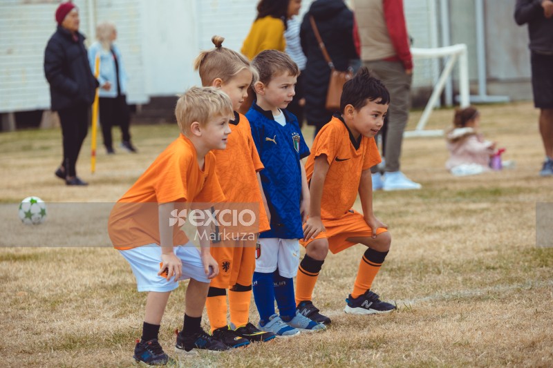 Four little children lineup at Little Dribblers soccer match