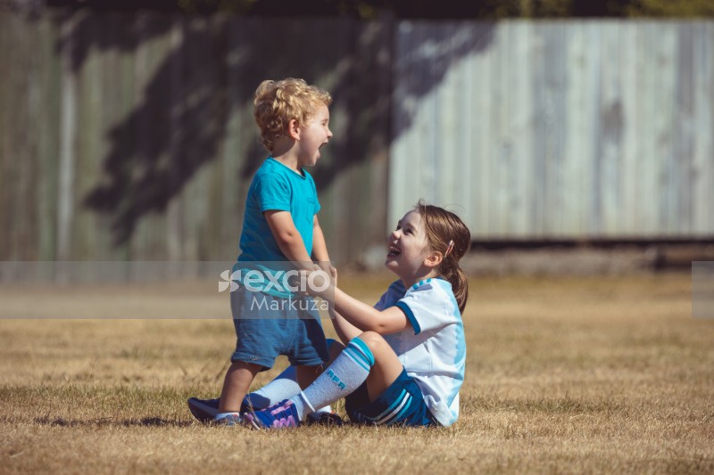 Little boy and girl laughing at Little Dribblers game