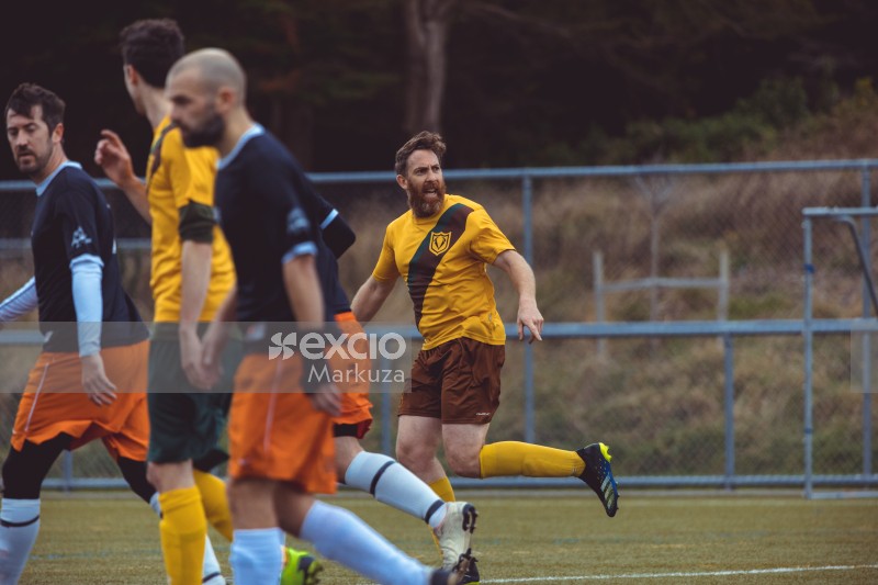 Bearded player looking back while running - Sports Zone sunday league