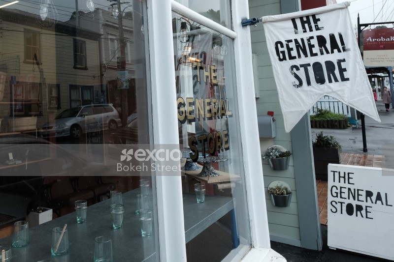 The General Store sign and reflection of the street