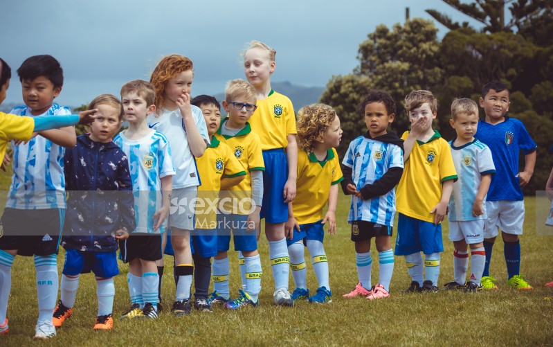 Little football players from various teams lineup - Little Dribblers