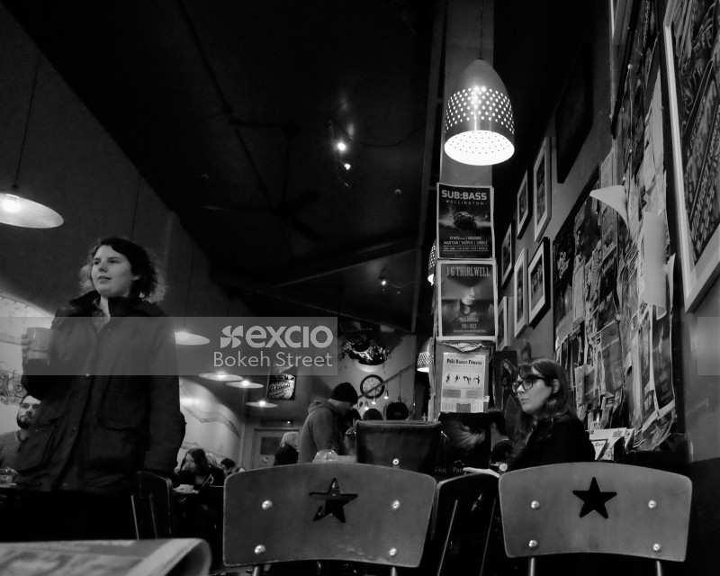 Customers in a coffee shop black and white