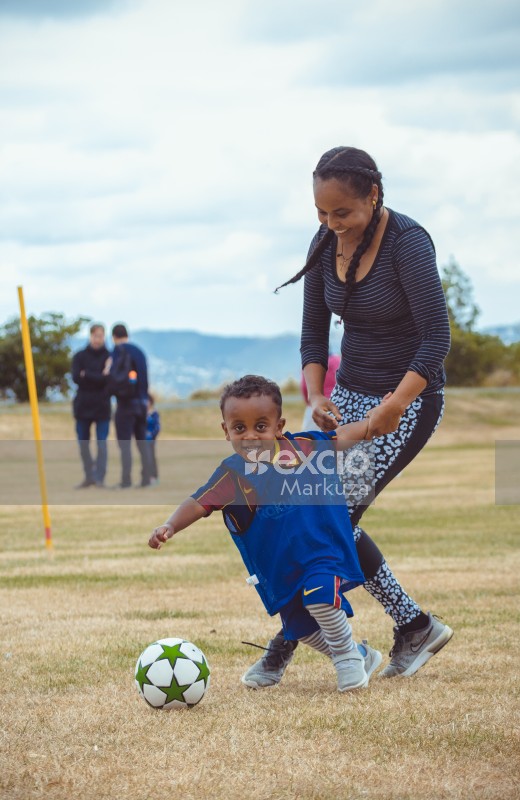 Mother playing with son at Little Dribblers football match