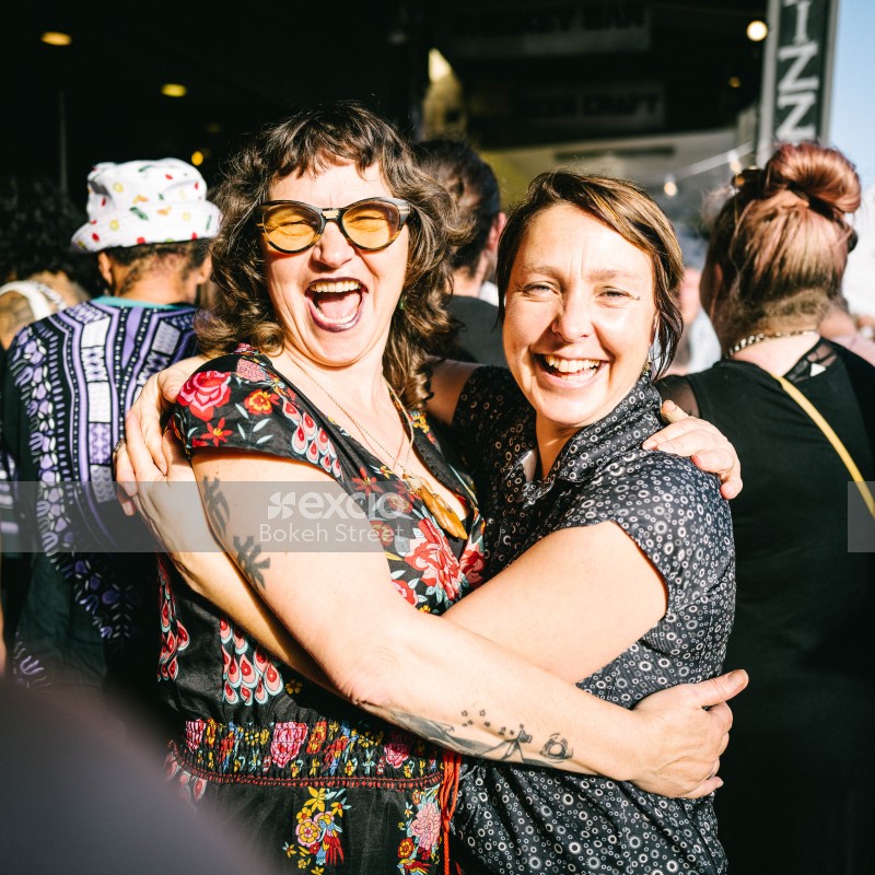 Two women hugging and smiling at Newtown festival 2021