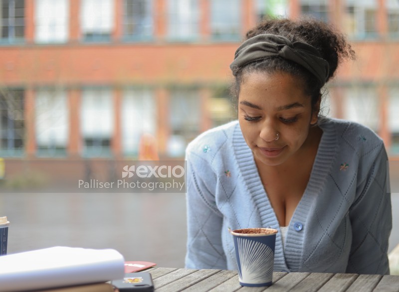 Young lady looking into her coffee cup