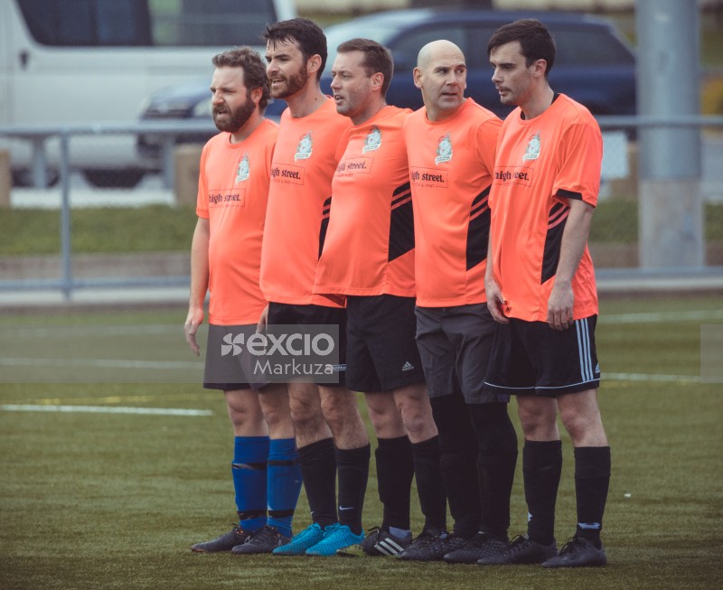 Five players in orange shirts form defence line - Sports Zone sunday league