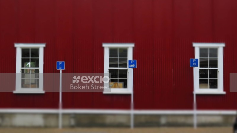 Blue parking signs and red building