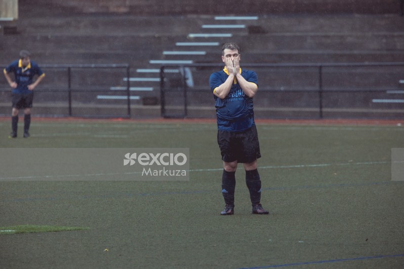 Football player covering face with hands during the rain - Sports Zone sunday league