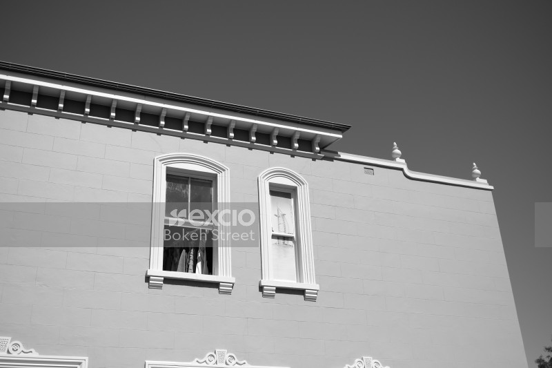 A building with small and large window black and white