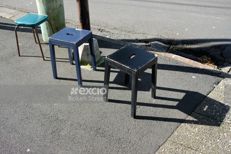 Three stools out in the sun by the road in Kilbirnie