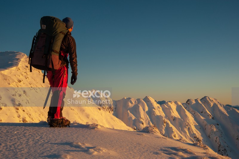Climber admires Sawtooth Ridge