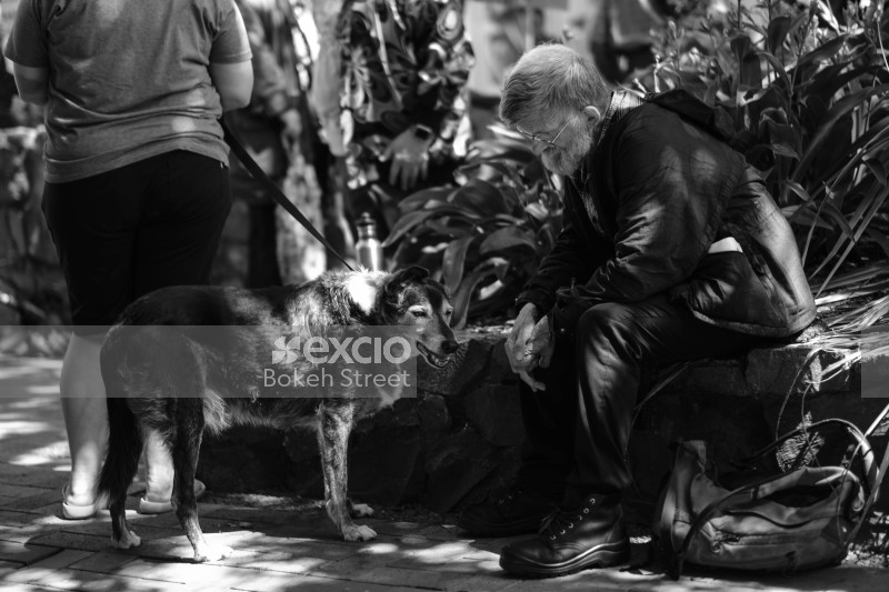 Old man and a dog on leash black and white