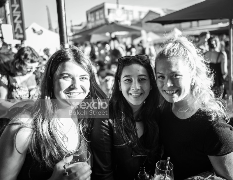 A trio of female friends posing for a picture at Newtown festival 2021 black and white
