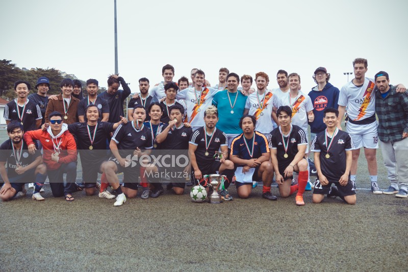 Opposing football teams with medals and trophy - Sports Zone sunday league