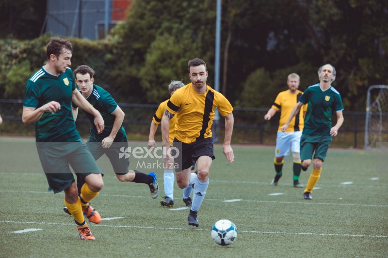 Football player keeping focus on the ball - Sports Zone sunday league