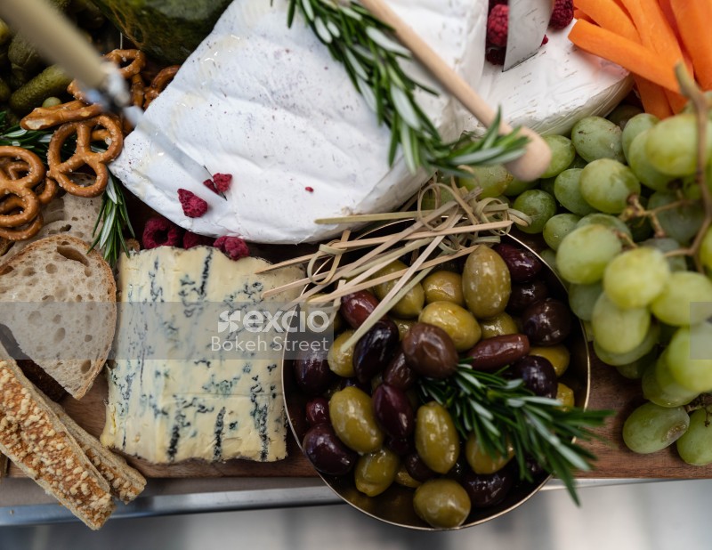 Cheese platter with olives and grapes