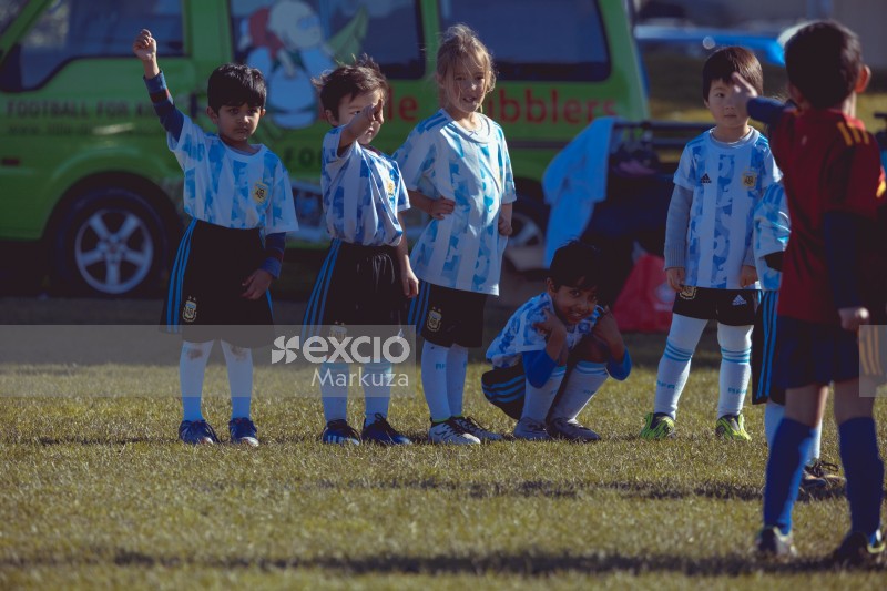 Teammates lineup at Little Dribblers football match