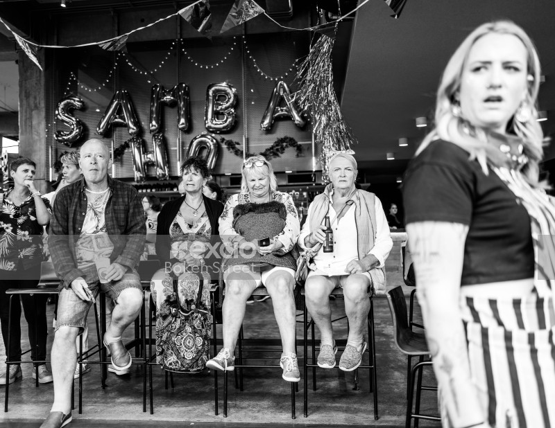 People sitting on chairs at Cuba Dupa 2021 monochrome