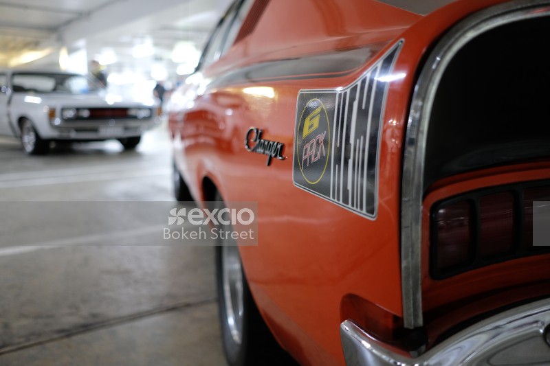 Classic orange Dodge Charger muscle car 6 pack Hemi bokeh