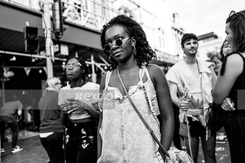 Black girl in sunglasses and dungarees