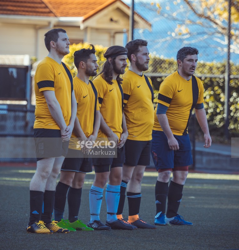 Five players wearing yellow Nike shirts stand in a line - Sports Zone sunday league