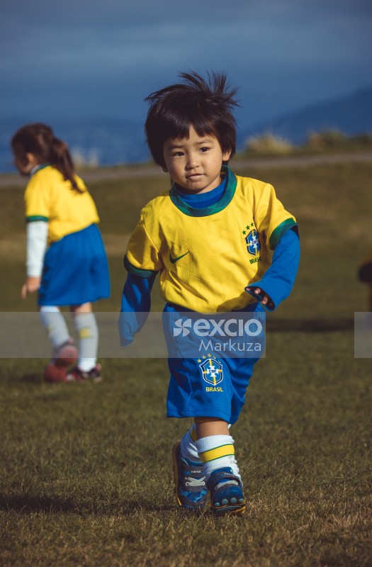 Little boy wearing Brasil kit at Little Dribblers soccer match