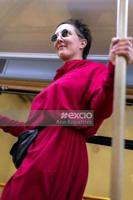 Young woman in red dancing in cable car