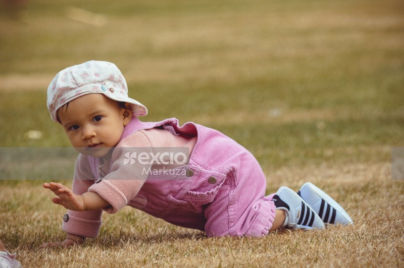 Toddler in pink dress and hat at Little Dribblers ball game