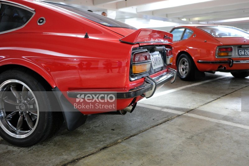 Classic red Datsun 240z tail lights and exhaust pipe