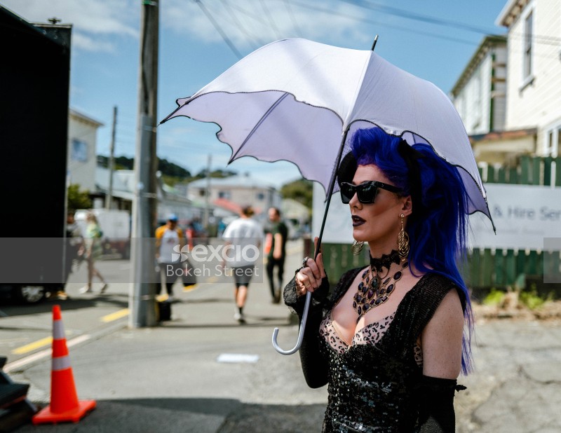 Woman holding umbrella at event