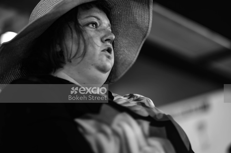 Black and white image of a woman wearing a hat