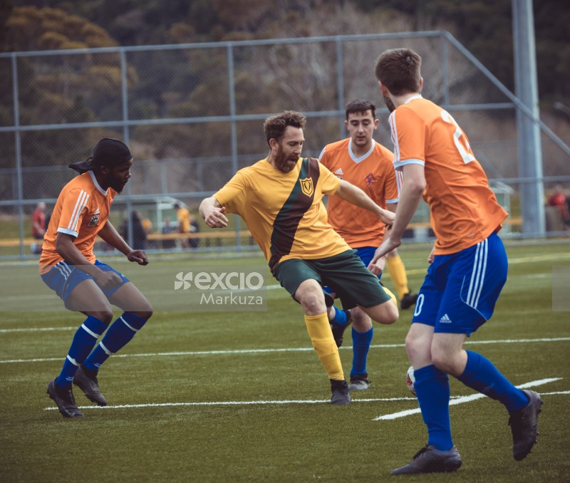 Guy in yellow jersey kicking football - Sports Zone sunday league