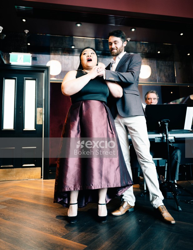 Male and female opera singers performing