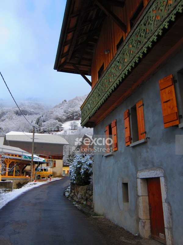 Road chalet and snow covered mountains at the Swiss Alps