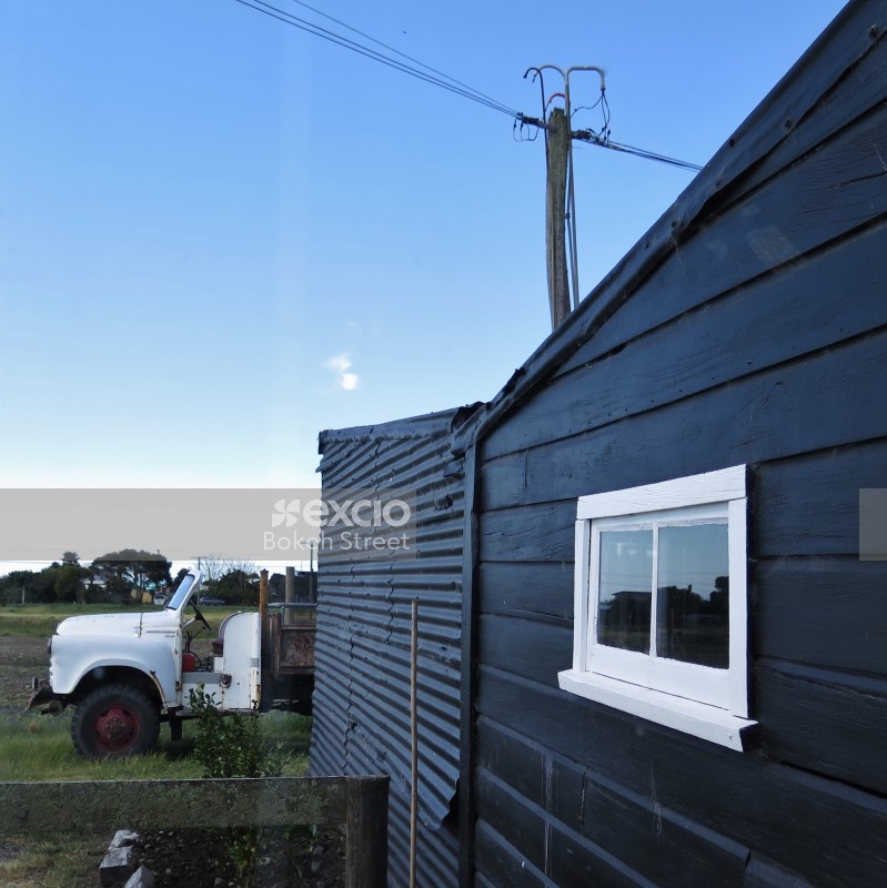 Old white truck and black coloured shack at Hawkes bay