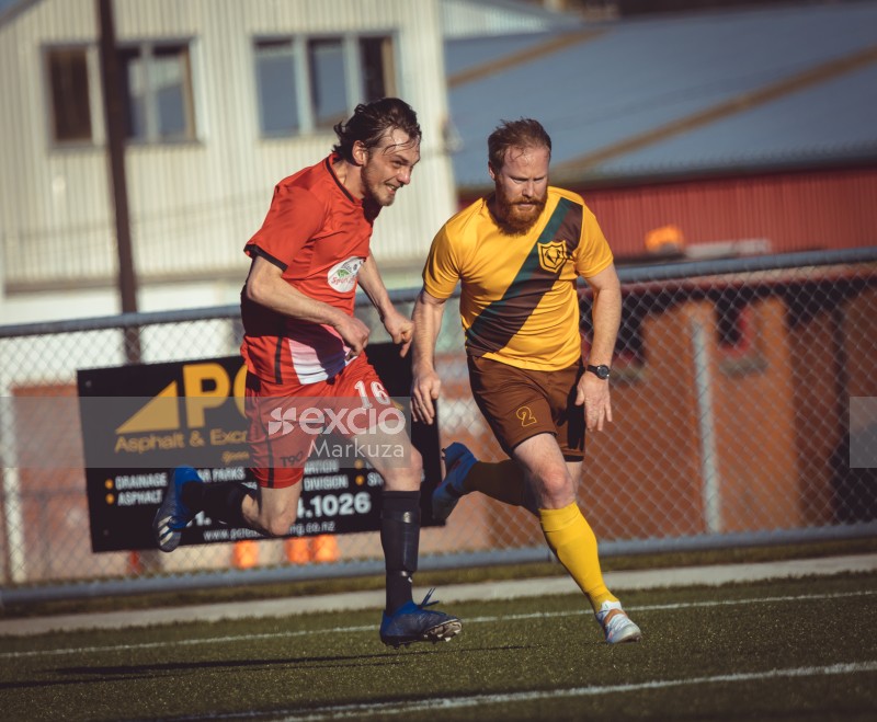 Two players dashing on the field at Hutt valley - Sports Zone sunday league