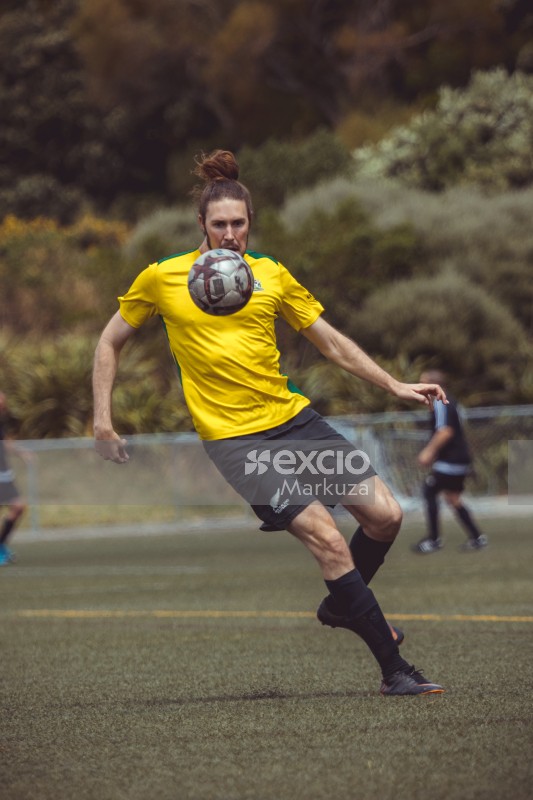 Player with man bun keeps eye on the bouncing ball - Sports Zone sunday league