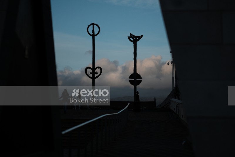 Silhouette of symbols on poles