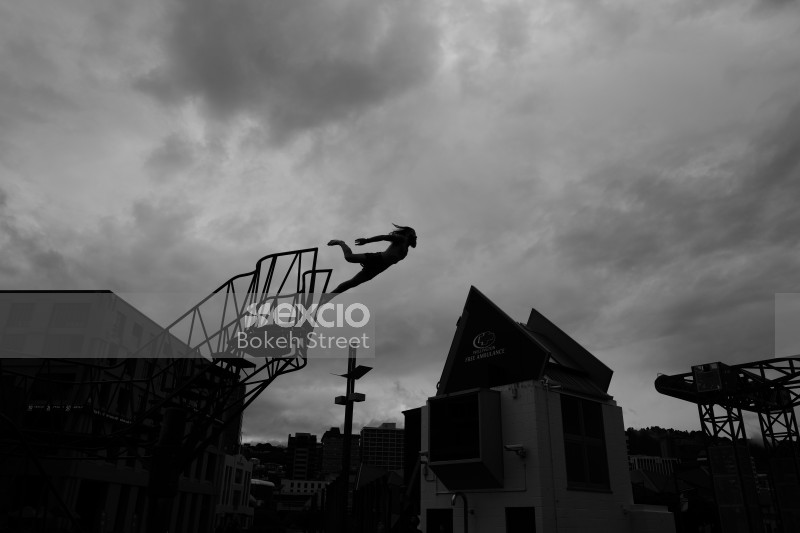 Long haired man taking a leap of faith black and white