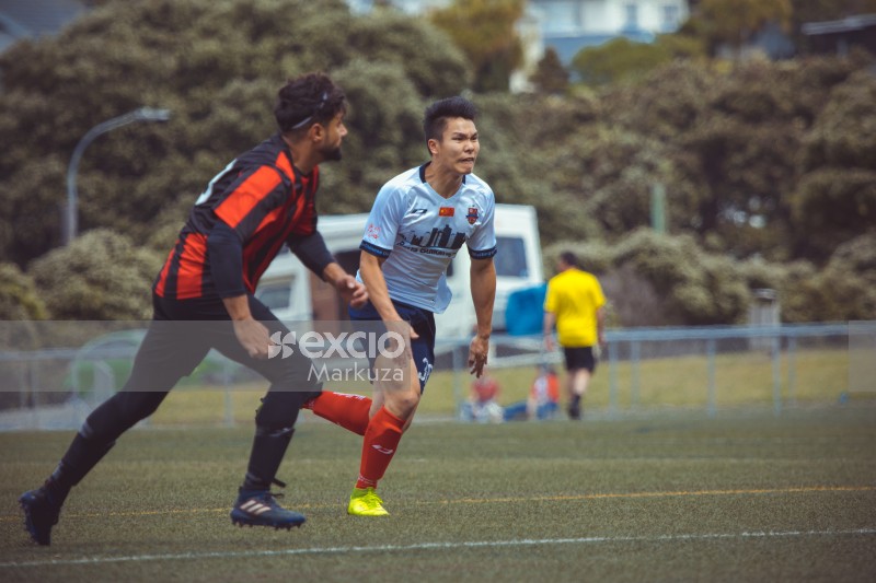 Asian player sprinting after ball - Sports Zone sunday league