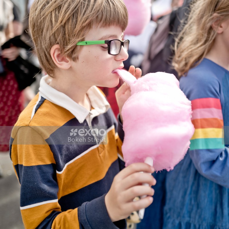 Nerdy kid eating pink cotton candy at Newtown festival 2021