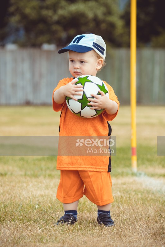 Kid wearing Netherland kit holding a football - Little Dribblers