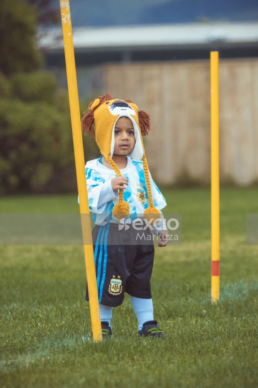 Boy in Argentine kit standing between two yellow poles at Little Dribblers