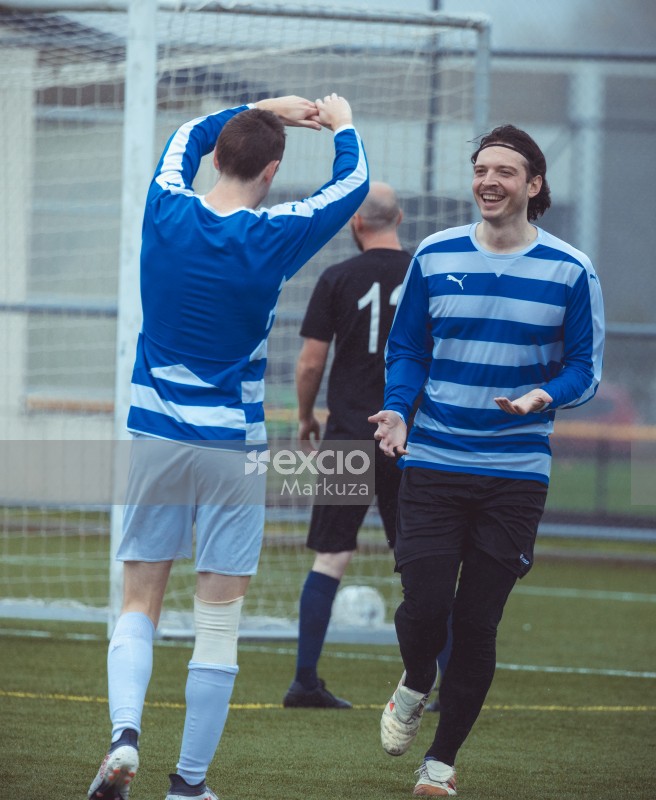 Smiling player getting a gesture of goodjob - Sports Zone sunday league