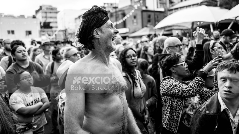 Laughing man with shirt off at Cuba Dupa 2021 monochrome
