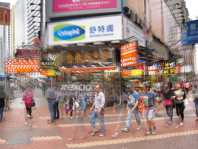 People and shop signs in the street of Hong Kong