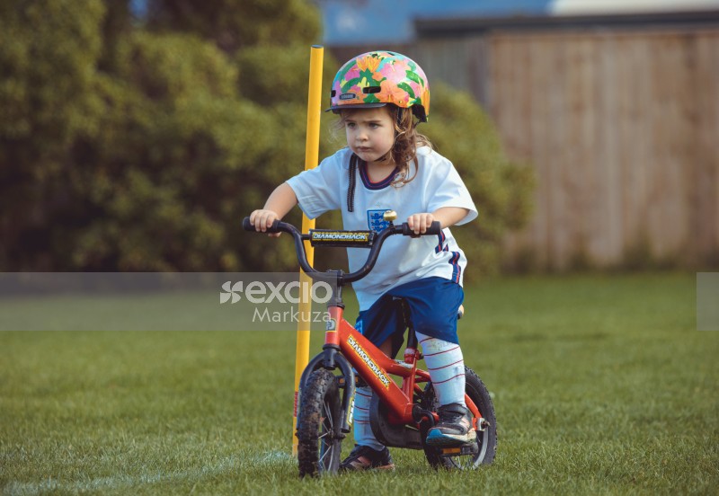 Little girl on a red bike