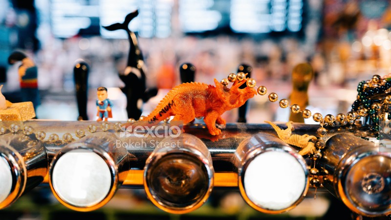 Bar taps superman triceratops pearl necklace and bokeh