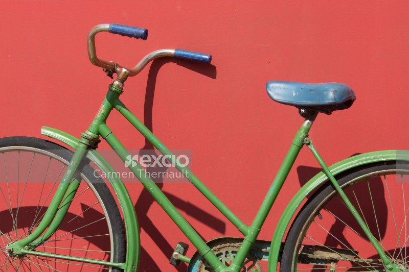Green bike against Red Wall